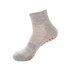 Grey gripper sock with a textured design and orange grip dots on the sole, featuring a logo.