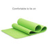 A green premium TPE yoga mat, rolled partially open, with a smooth surface and a logo on it.