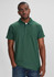 A green polo shirt with a collar and rolled sleeves on a model, featuring a logo.