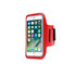 A red arm band designed to hold a smartphone securely, featuring a cutout for the screen and a brand logo.