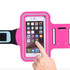 A pink cell phone arm band with a transparent pocket for a phone and adjustable strap. It features a logo.
