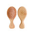 A small bamboo hairbrush featuring a wooden design with orange bristles and a branded logo on the handle.