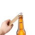 A drink bottle opener with a metallic finish and a beige handle is poised above a brown glass bottle.