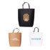 Three large boutique paper bags in black, brown, and white, each with unique designs and logos.