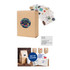 A large square gift box in natural brown with a circular logo, accompanied by various colourful stickers.