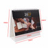 A desk calendar with a spiral binding, featuring a January page, predominantly black and white with a 2027 date.