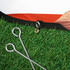 An oval-shaped pop-up banner with a grass-like base, featuring attachment hooks and pegs.