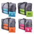 A grey travel compressed bag with bright green, pink, and orange accents, accompanied by colourful pouch options.