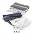 A set of two Ohau Throw Blankets in navy blue and white with fringe detailing and a logo.