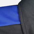 A close-up of a black polo shirt featuring a blue collar and sleeve detailing, with visible stitching and fabric texture.