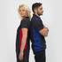 A black polo shirt featuring red and blue accents, modelled by a woman and a man standing back to back.