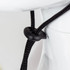 A close-up of a black adjustment toggle on a drawstring, attached to a white hat. The hat features a wide brim.