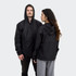 A black windbreaker jacket featuring a hood, displayed on a male and female model from the front and back.