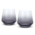 A set of two whiskey glasses in a gradient of clear to dark grey, featuring a modern design and a logo on the base.