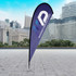 A large tear drop flag kit in purple with a logo, set against a modern cityscape background.