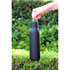 A drink bottle in matte black with a metal loop, designed for easy carrying. It has a sleek, minimalist appearance.