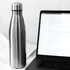 A drink bottle with a sleek stainless steel finish, featuring a logo, next to a laptop and papers.