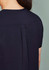 A women's rose tunic scrub top, featuring a sleek design with a pleat detail at the back. The fabric is dark navy.