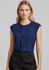 A women's navy top featuring a stylish ruffled design and cap sleeves, paired with black trousers.