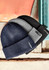 A collection of three Unisex Streetworx beanies in navy, grey, and black, featuring a logo on the band.