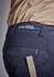 A close-up of navy shorts featuring a branded waistband and a ruler for measuring, highlighting the fabric's texture.