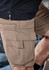 Curved cargo shorts in a light brown colour featuring multiple pockets and a logo. Ideal for casual wear.