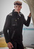 A model wearing a black unisex lightweight 1/4 zip polar fleece with a front pocket, standing next to an aircraft.