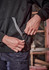 A unisex, black water-resistant hoodie with a front pocket and grey detailing, designed for workwear.
