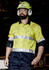A men's industrial long sleeve shirt in bright yellow and navy, featuring reflective hoop tape. Includes a logo.
