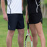 Dri Gear XTF shorts in navy, featuring a logo, worn by a man and woman standing on grass with a tennis racket.