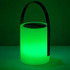 A green, cylindrical speaker lamp with a black handle and a metallic top, emitting glowing light.