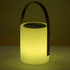A lamp-shaped speaker in soft yellow with a metal handle and a speaker grating on top. It features a minimalist design.