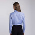 A women's button-up shirt in light blue, featuring a pointed collar and buttoned cuffs, with a subtle logo.