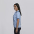 A light blue women's polo shirt with contrasting trim and a logo on the chest.