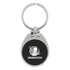 A keychain with a silver metallic finish and a black textured circular centre featuring a logo.