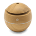 A round wooden diffuser in a light timber finish with a circular design and a power button.