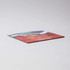 A 50mm x 50mm fridge magnet with a colourful design and a logo on it, featuring a flat edge.