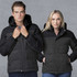 A black and grey rain jacket features a hood, with a stylish design for both men and women. It has a logo on the front.