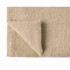 A bath towel in organic cotton, featuring a soft, beige texture and a folded corner. Includes a logo.
