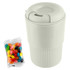 A reusable coffee cup in light grey with a ribbed base, accompanied by a pack of colourful jelly beans.