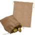 A jute bag in a natural brown colour, featuring a drawstring closure, with some potatoes inside.