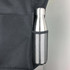A stainless steel drink bottle nestled in a mesh pocket of a black nylon shopping tote.