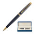 A matte black ballpoint pen with gold accents, presented in a blue box with a cream interior and a logo.