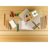 A collection of natural wood full-size coloured pencils in various colours, arranged with paper and accessories on a wooden surface.