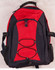A red and navy Smartpack Backpack featuring adjustable straps and a front bungee cord. It includes side mesh pockets and a logo.