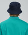 A navy bucket hat with a contrasting underbrim, shown from the back, paired with a teal shirt.