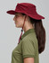 A burgundy surf hat with a wide brim and adjustable chin strap, worn by a person in profile.