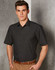 Men's short-sleeve button-up shirt in black with a pin dot pattern and a chest pocket. Features a logo.