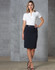 A model wears a black utility skirt paired with a white top, set against a textured grey background.