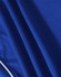 A close-up of a blue polo shirt made from textured fabric with contrasting stripes and a logo.